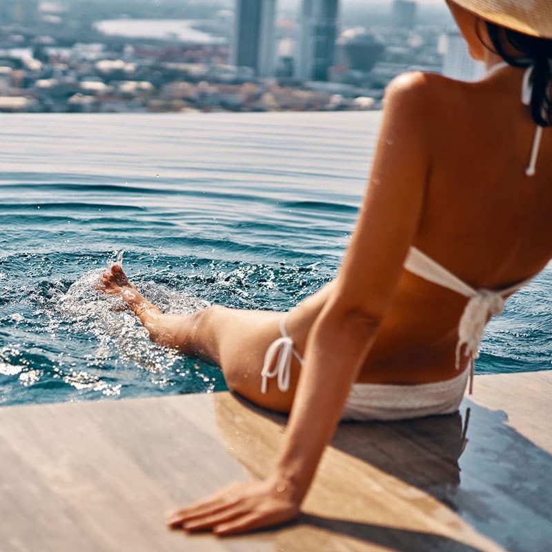 girl siiting in the side swimming pool