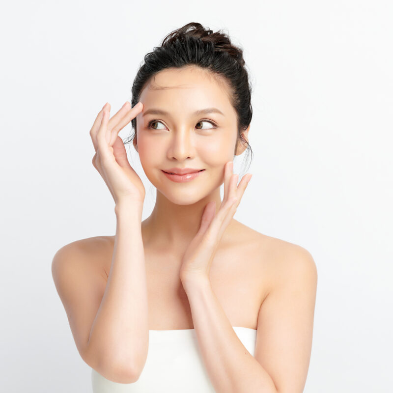 Beautiful young asian woman with clean fresh skin on white background.